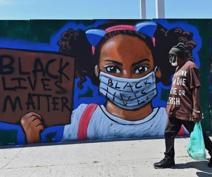 A person walks past a street mural by artist Lexi Bella on June 16, 2020 in the Brooklyn Borough of New York City. (Photo by Angela Weiss / AFP) / RESTRICTED TO EDITORIAL USE - MANDATORY MENTION OF THE ARTIST UPON PUBLICATION - TO ILLUSTRATE THE EVENT AS SPECIFIED IN THE CAPTION (Photo by ANGELA WEISS/AFP via Getty Images)