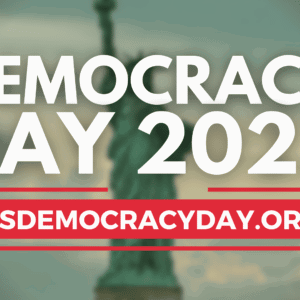 DECORATION ONLY: White text against a blurred background image of the Statue of Liberty. The text reads, "DEMOCRACY DAY 2023: Sept. 15, 2023 | usdemocracyday.org"