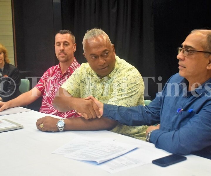 The Fiji Times editor in chief Fred Wesley and Dr Shalendra Naidu after signing the MOU . Picture: JONA KONATACI